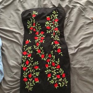 A slim black dress with roses going down